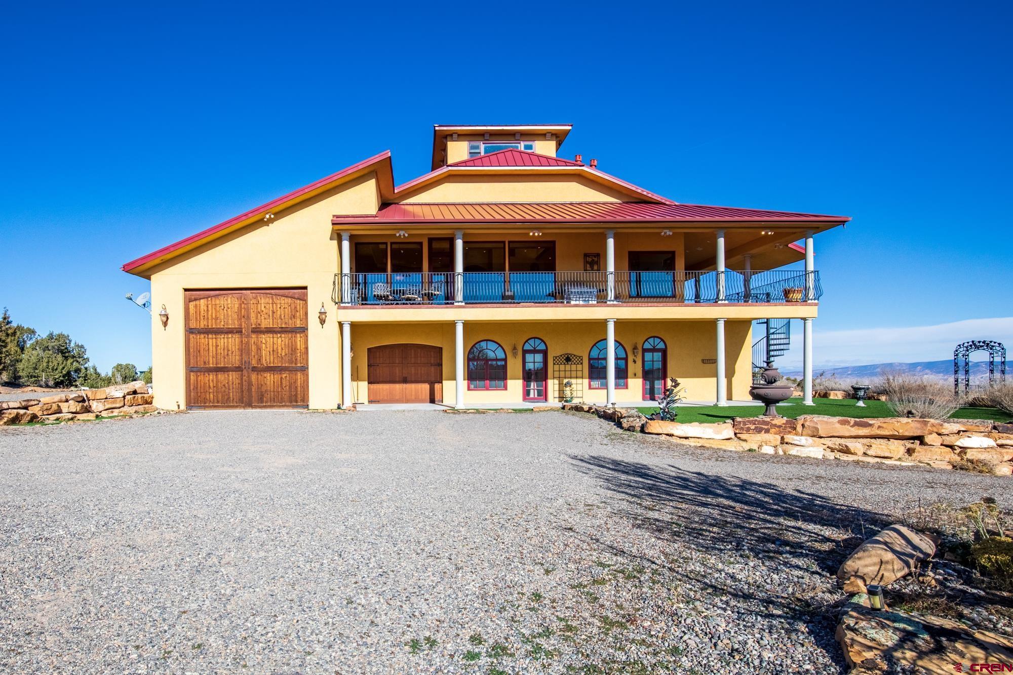 19754 Dave Wood Road Montrose, CO 81403 - Photo 34 of 35 a front view of a house with a yard