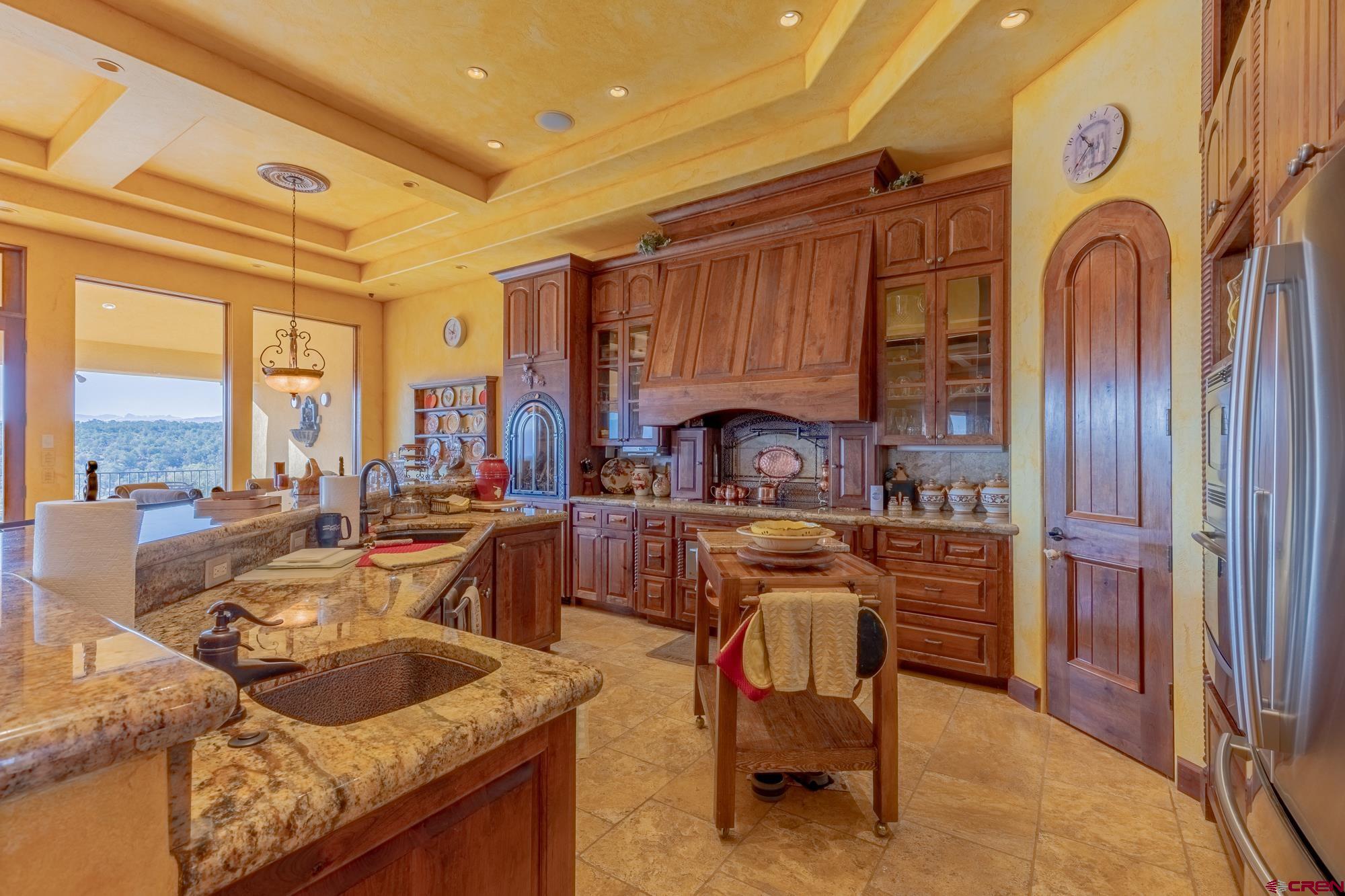 19754 Dave Wood Road Montrose, CO 81403 - Photo 4 of 35 a kitchen with granite countertop a sink and a refrigerator