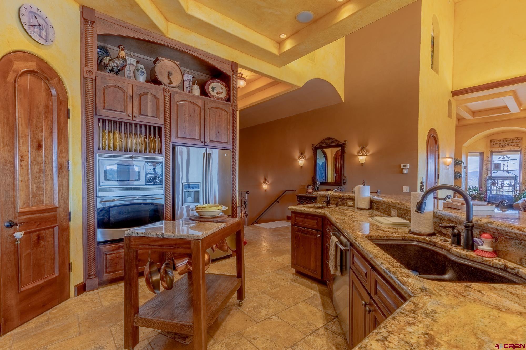 19754 Dave Wood Road Montrose, CO 81403 - Photo 6 of 35 a kitchen with stainless steel appliances granite countertop a sink and cabinets