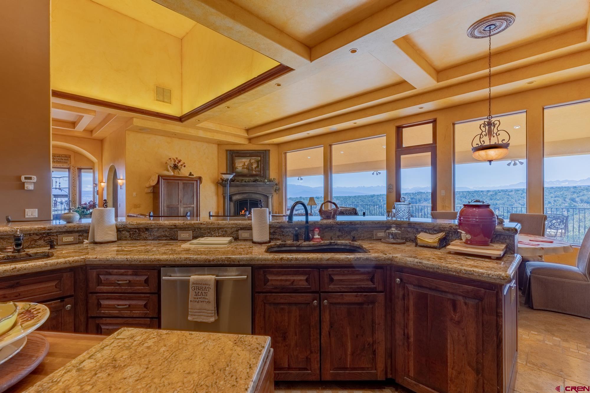 19754 Dave Wood Road Montrose, CO 81403 - Photo 7 of 35 a kitchen with granite countertop a sink and a counter