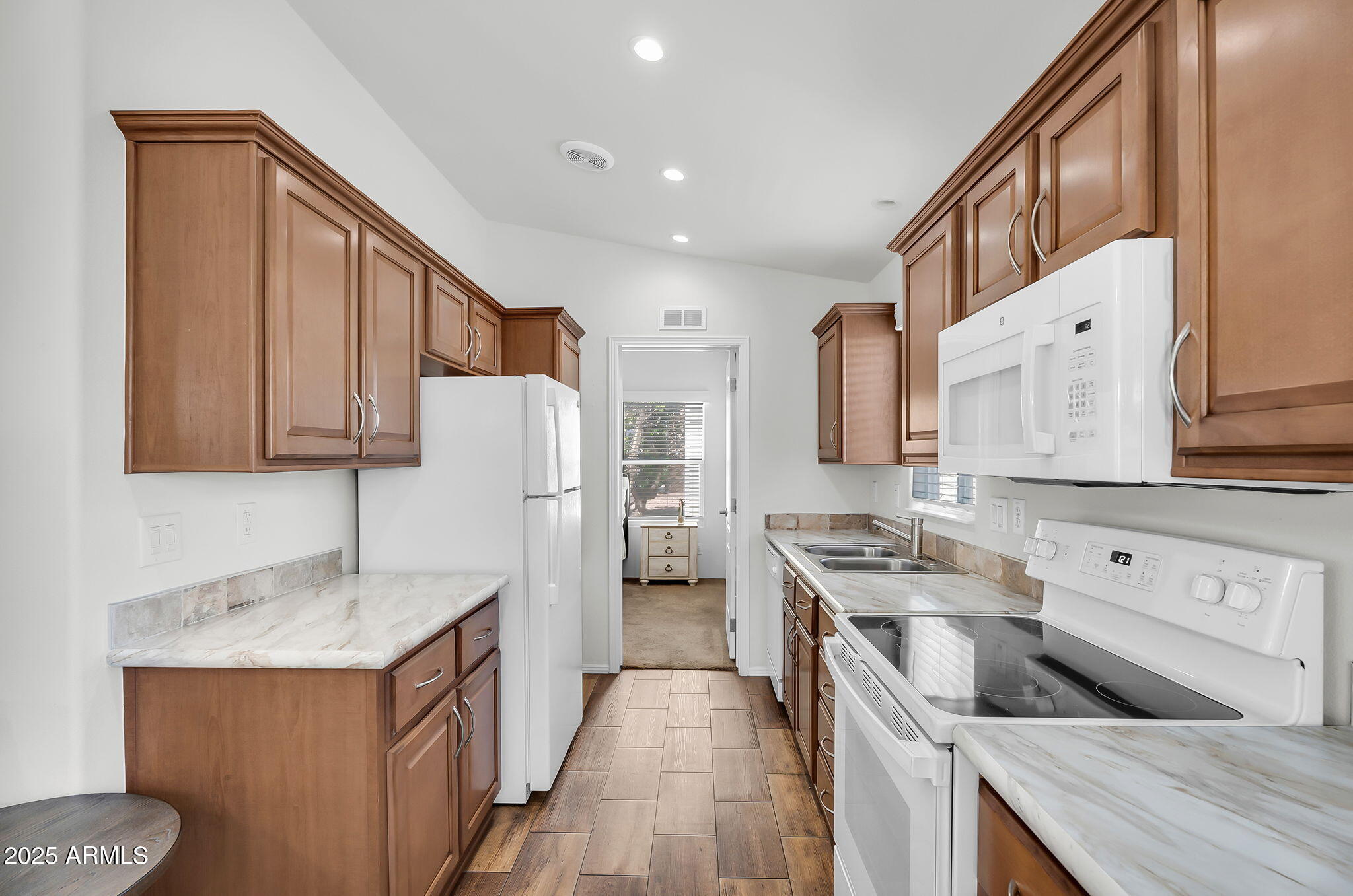 8865 East Baseline Road, Unit 802 Mesa, AZ 85209 - Photo 5 of 44 a kitchen with a sink stove and refrigerator