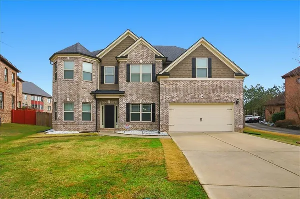 a front view of a house with a yard