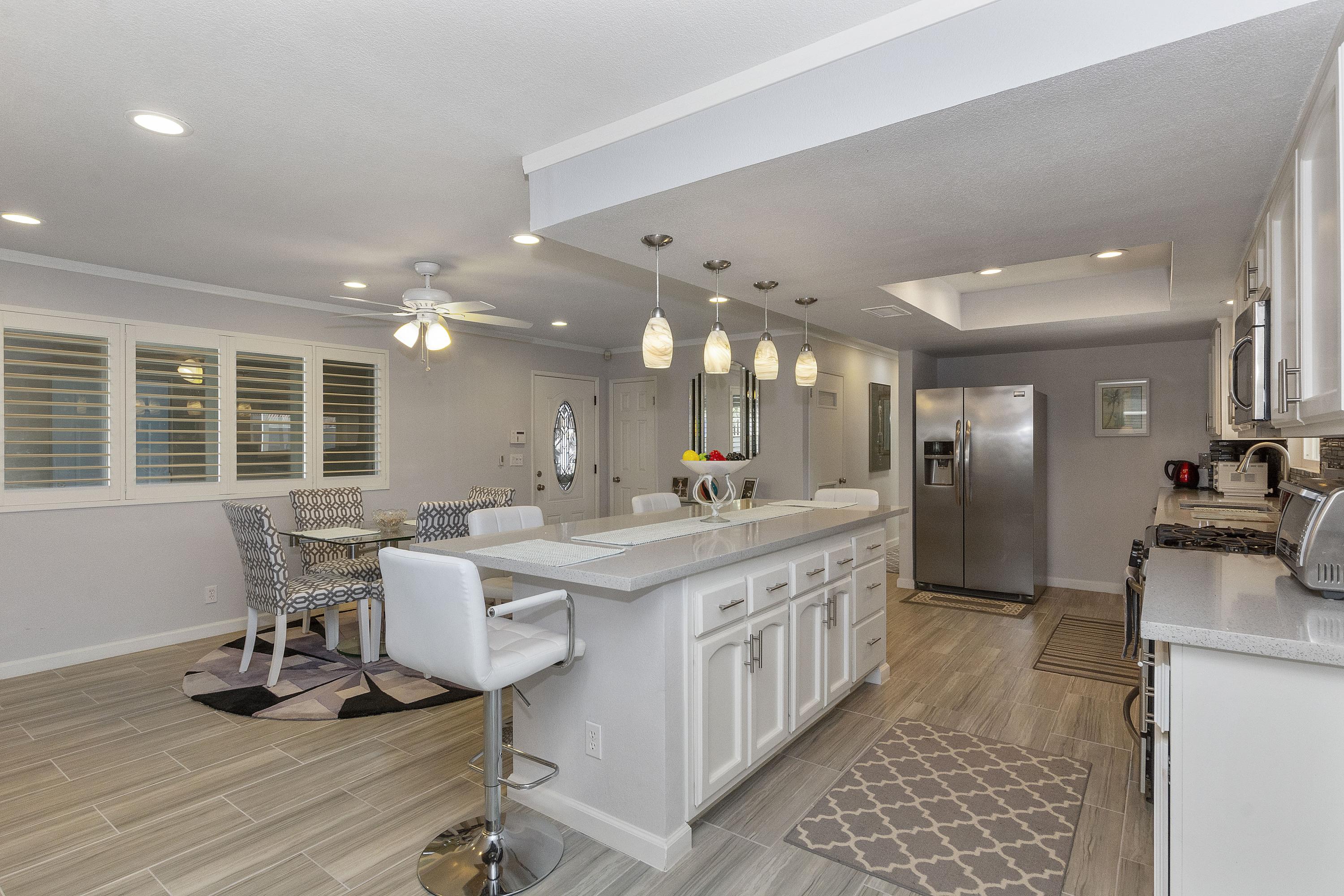 70061 Cobb Road Rancho Mirage, CA 92270 - Photo 12 of 33 a large white kitchen with a large window