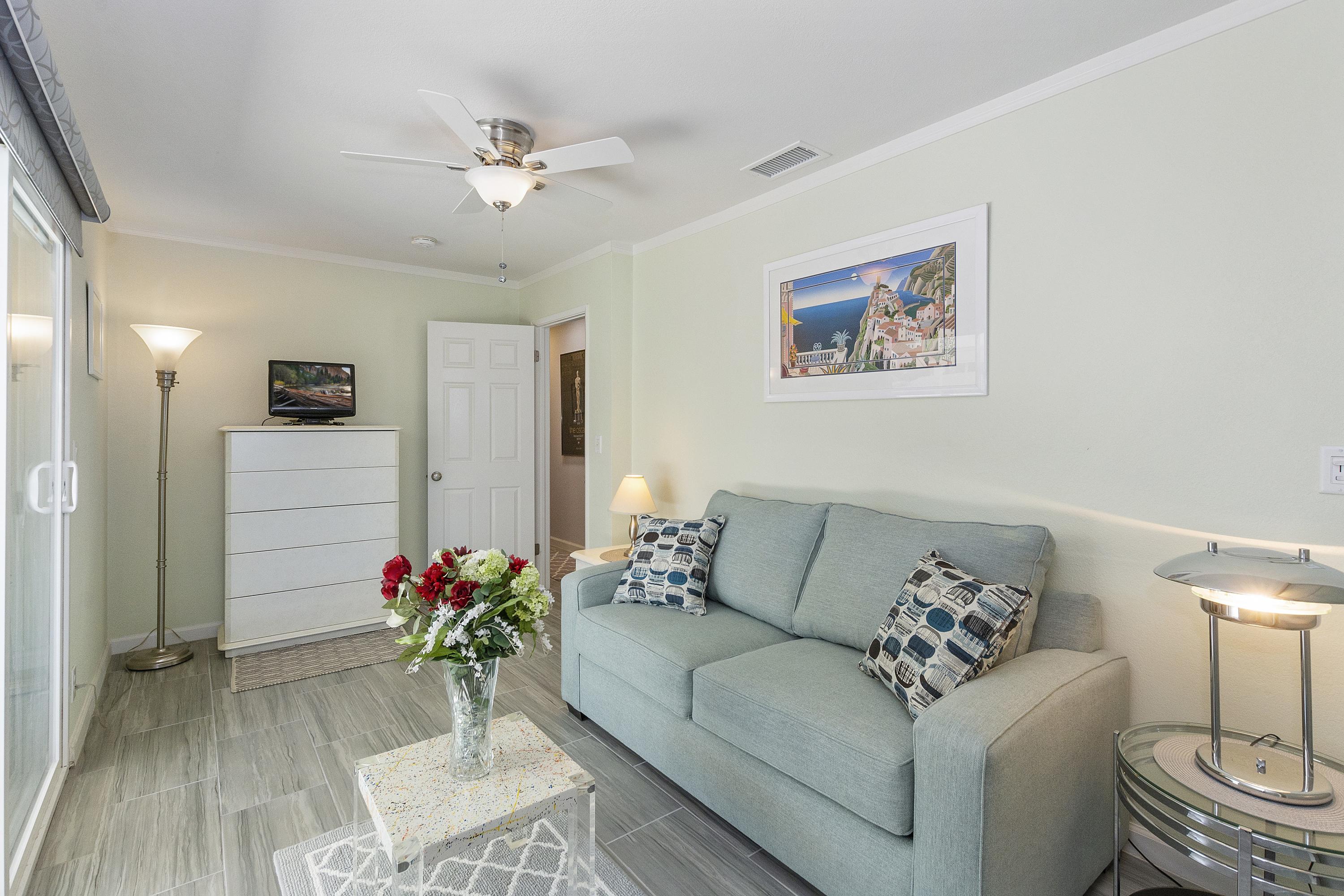 70061 Cobb Road Rancho Mirage, CA 92270 - Photo 23 of 33 a living room with furniture and a chandelier