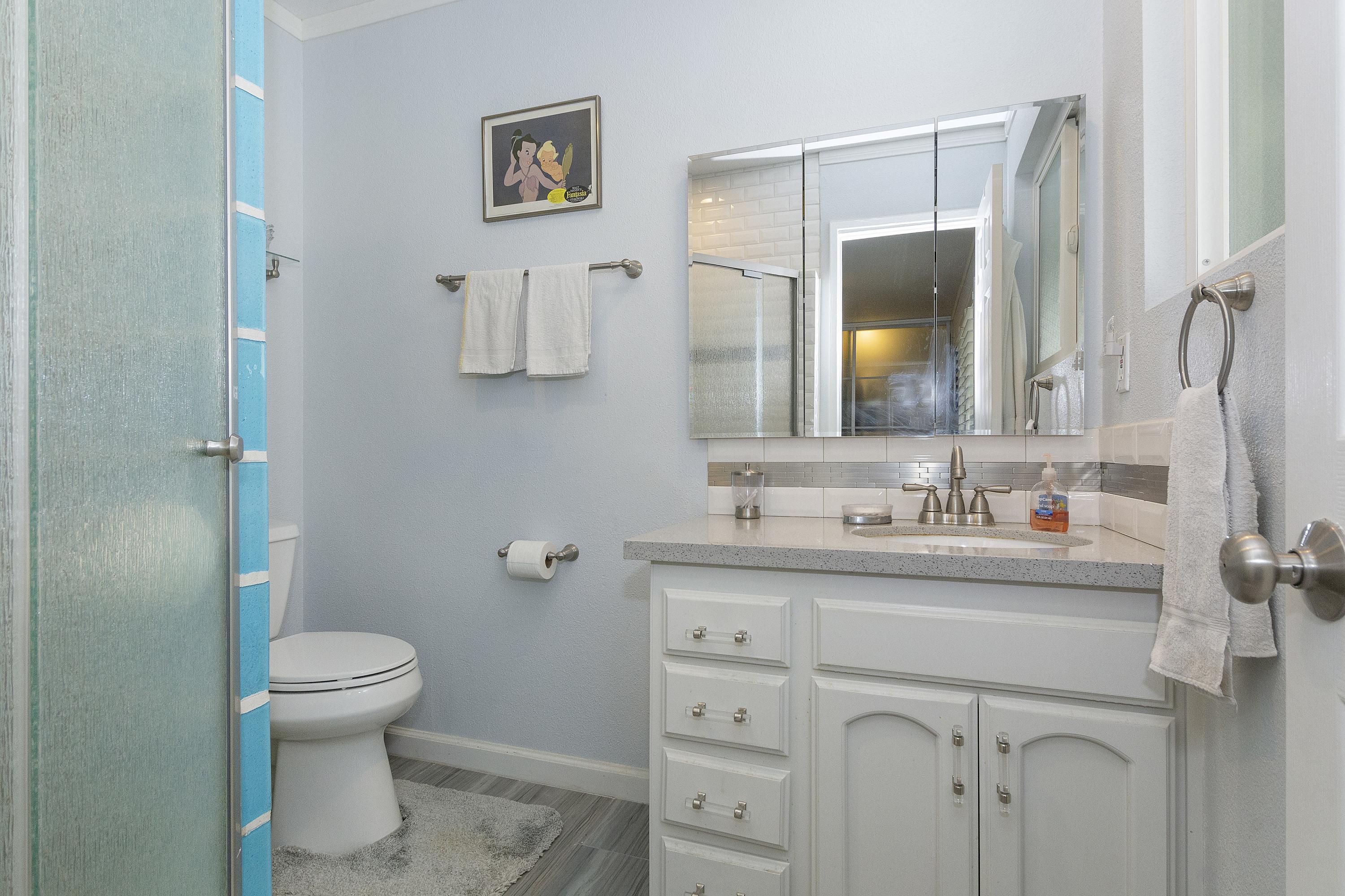 70061 Cobb Road Rancho Mirage, CA 92270 - Photo 28 of 33 a bathroom with a granite countertop sink toilet and mirror