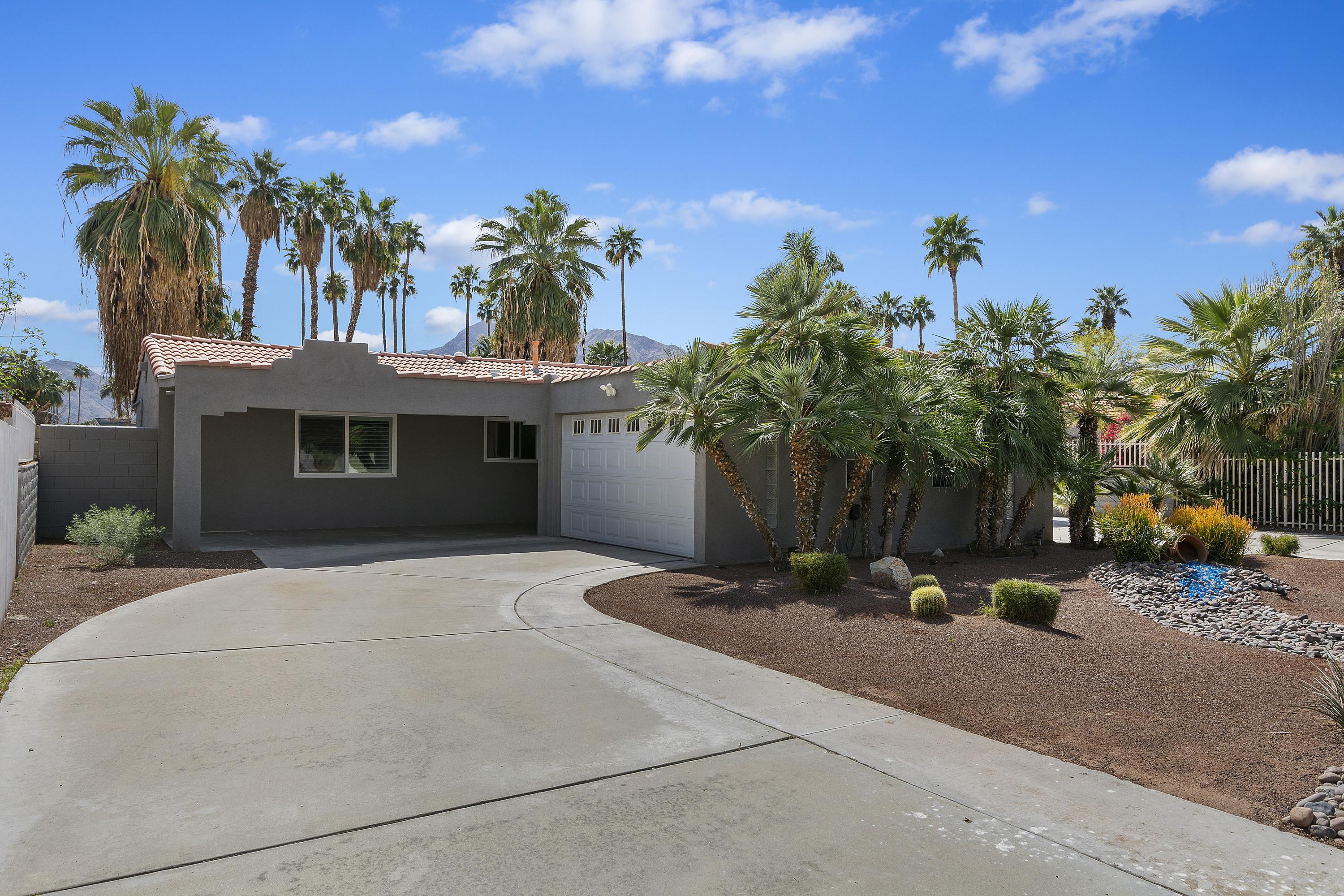 70061 Cobb Road Rancho Mirage, CA 92270 - Photo 4 of 33 a view of a house with palm trees and a small yard