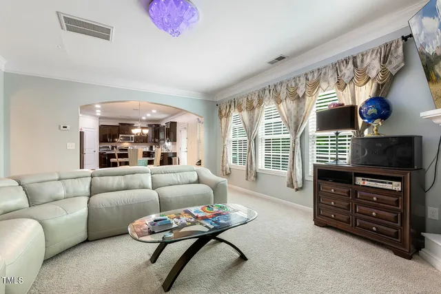 a living room with furniture a ceiling fan and a window