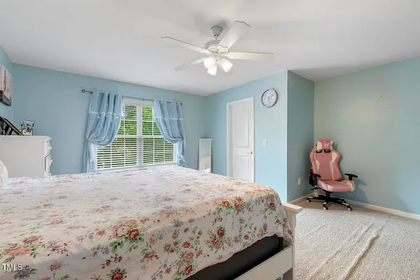 a bedroom with a bed and a large window