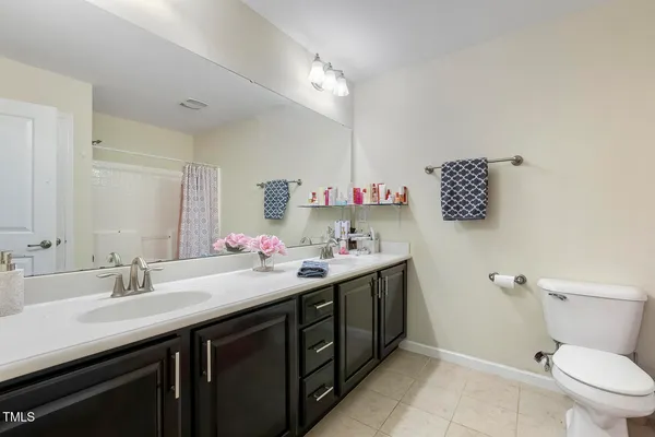a bathroom with a sink double vanity and a toilet