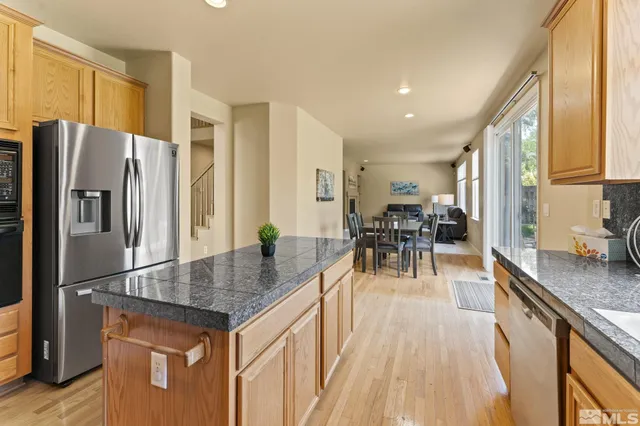 a kitchen with a table chairs sink and cabinets