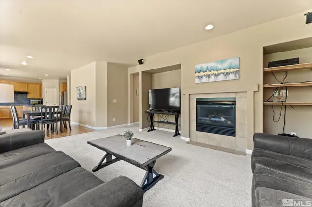 a view of a hallway with a tv and couches in a room