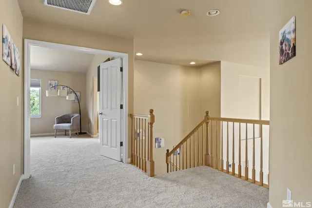 a bedroom with a bed chair and window
