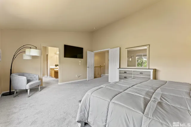 a bathroom with a double vanity sink a toilet a mirror and a glass door