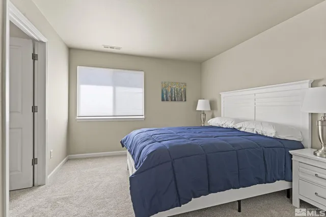 a bedroom with a bed and a lamp