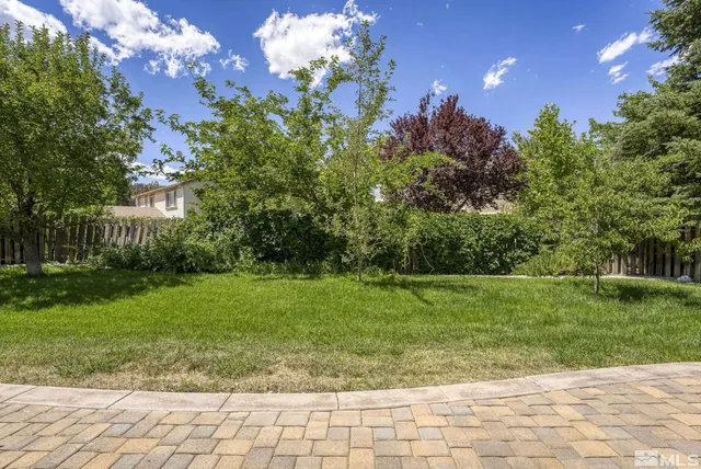 a house view with a sitting space and garden