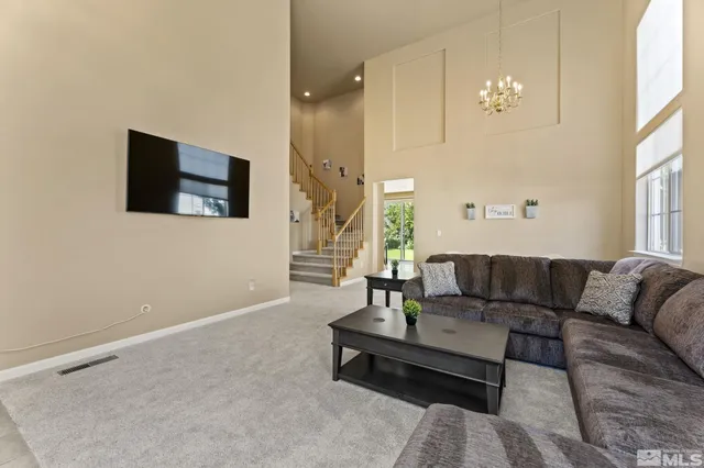 a kitchen with stainless steel appliances granite countertop a refrigerator a sink dishwasher a stove and white countertops with wooden floor