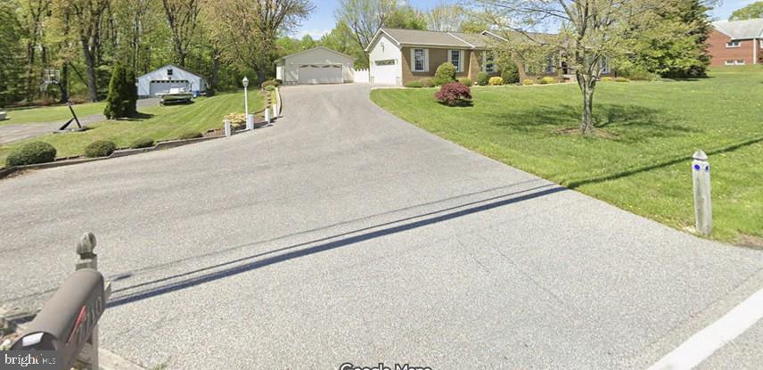 7710 Gum Spring Road Baltimore, MD 21237 - Photo 2 of 8 a view of a street with a building and a street sign