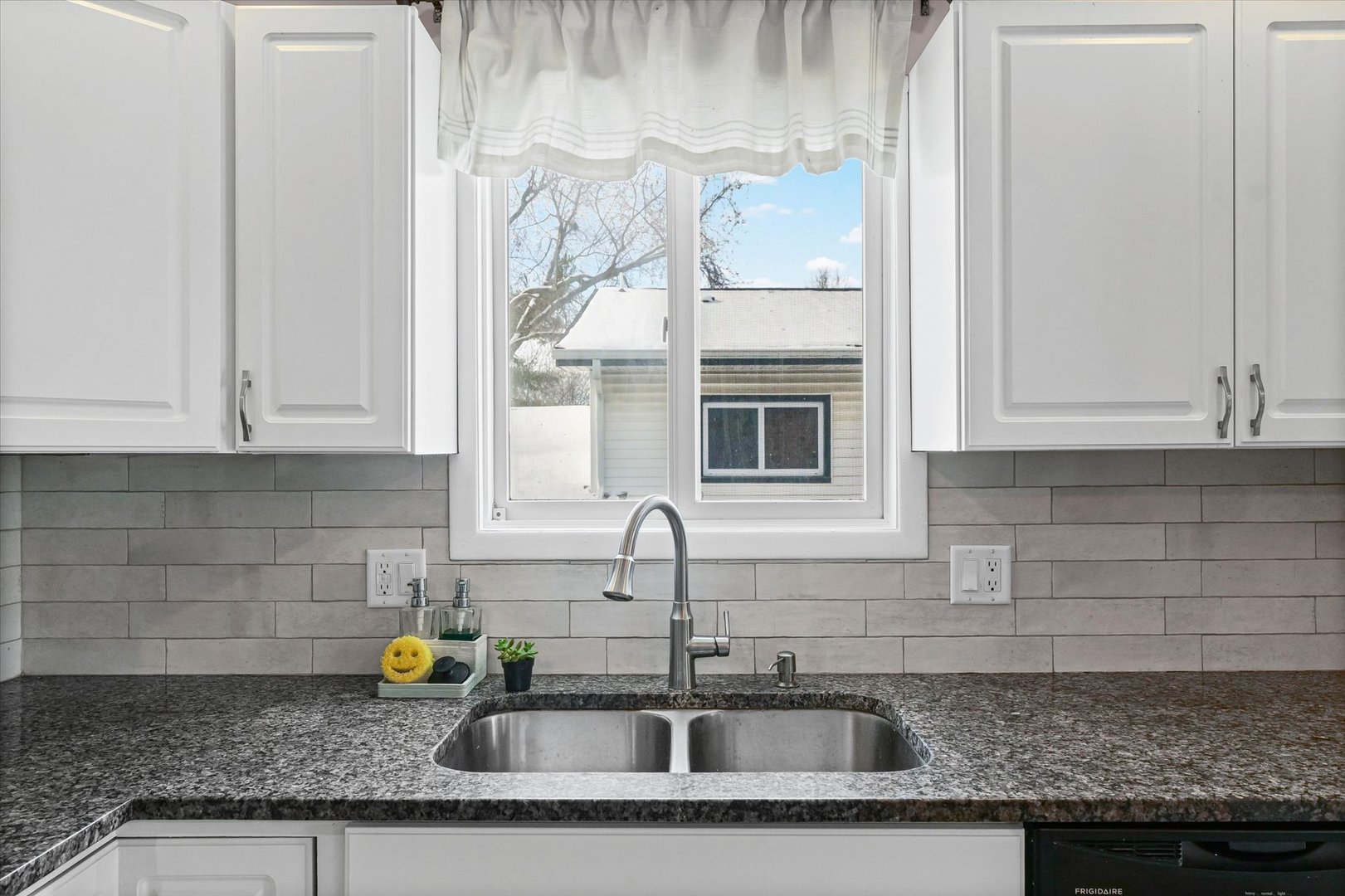 702 Devonshire Drive Champaign, IL 61820 - Photo 12 of 37 a kitchen with granite countertop a sink and cabinets