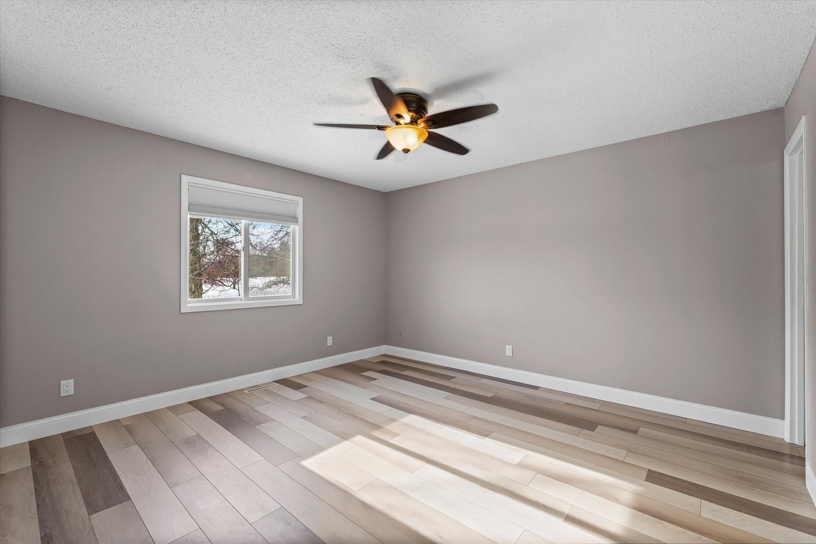 702 Devonshire Drive Champaign, IL 61820 - Photo 15 of 37 a view of a room with a ceiling fan and a window