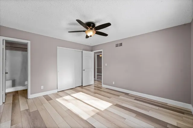 a bathroom with a granite countertop sink toilet a mirror a vanity and shower