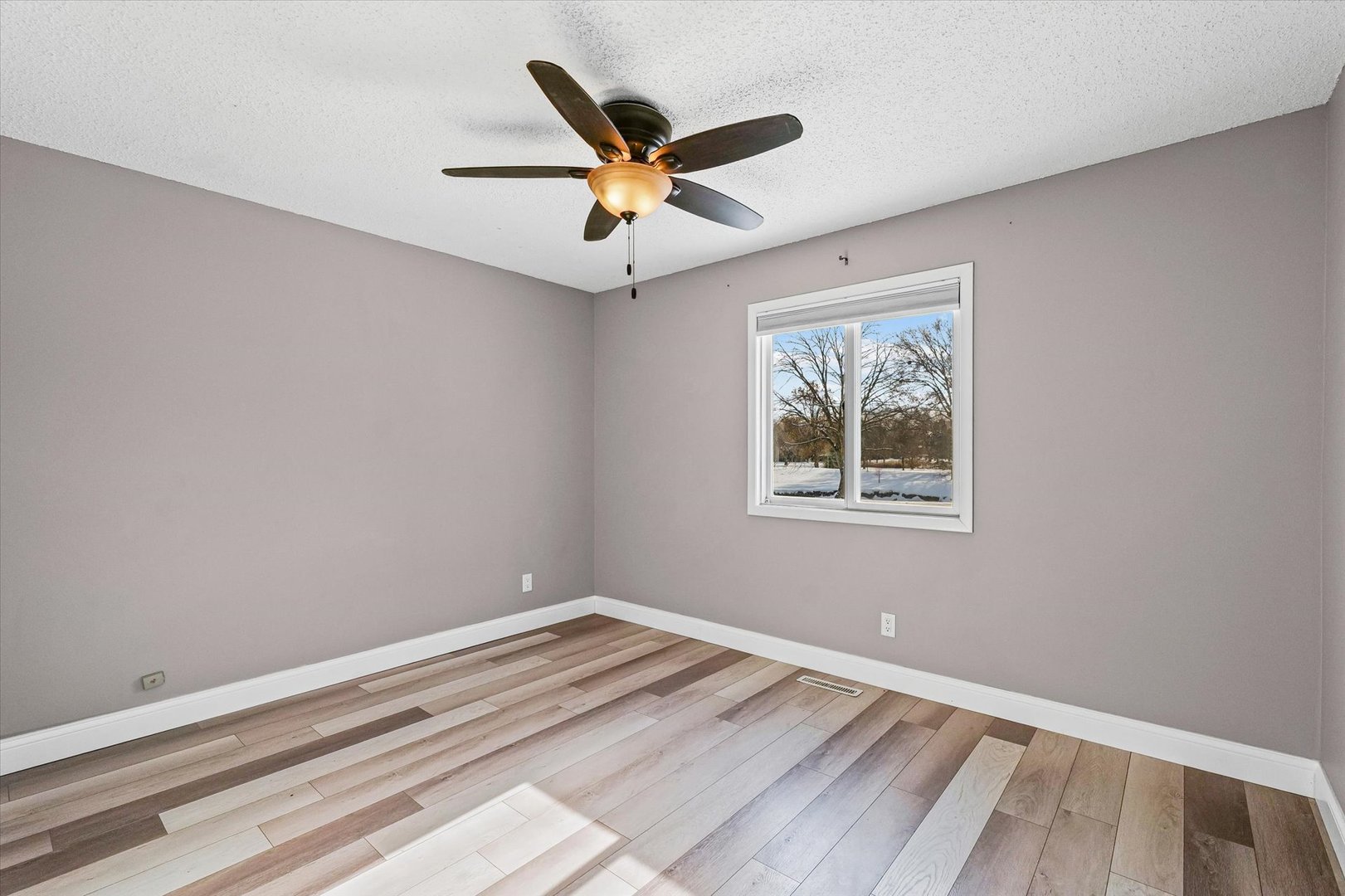 702 Devonshire Drive Champaign, IL 61820 - Photo 18 of 37 a view of a ceiling fan with wooden floor