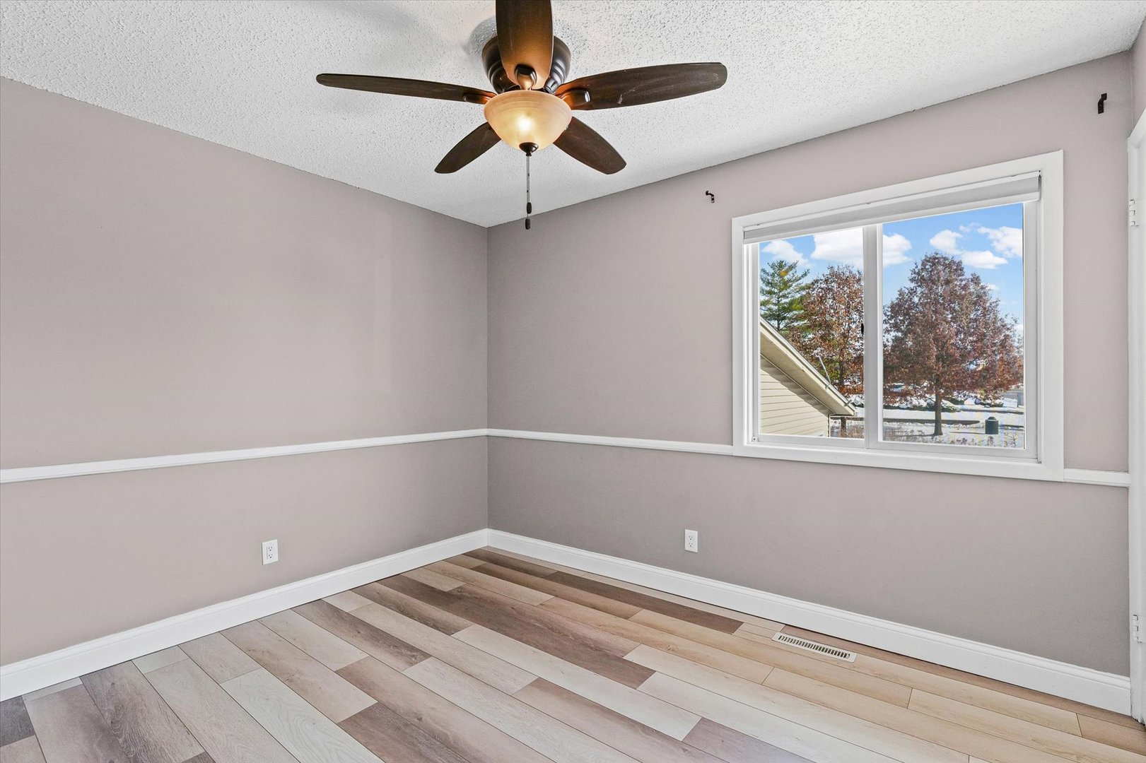 702 Devonshire Drive Champaign, IL 61820 - Photo 20 of 37 an empty room with a window and a ceiling fan