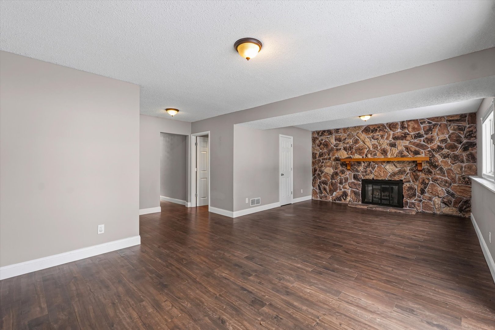 702 Devonshire Drive Champaign, IL 61820 - Photo 23 of 37 a view of empty room with wooden floor and fireplace