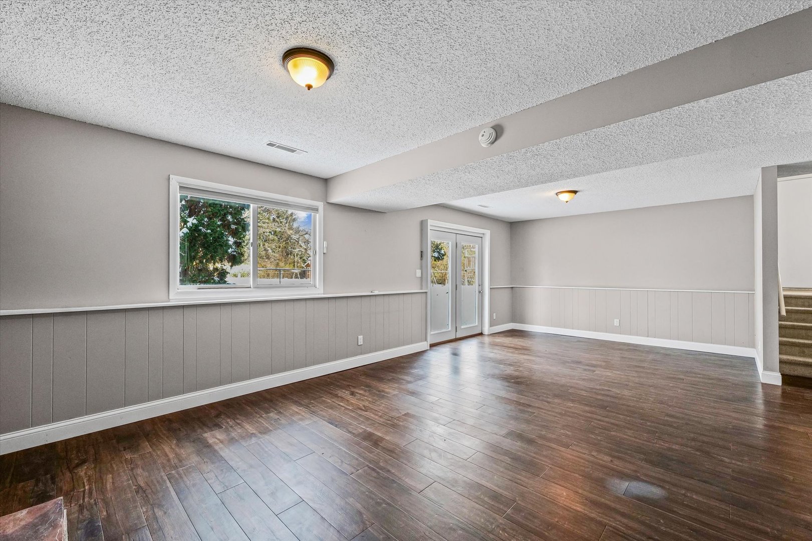 702 Devonshire Drive Champaign, IL 61820 - Photo 24 of 37 a view of an empty room with wooden floor and a window