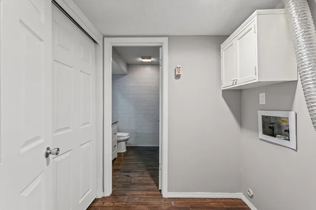 a bathroom with a granite countertop sink toilet and mirror