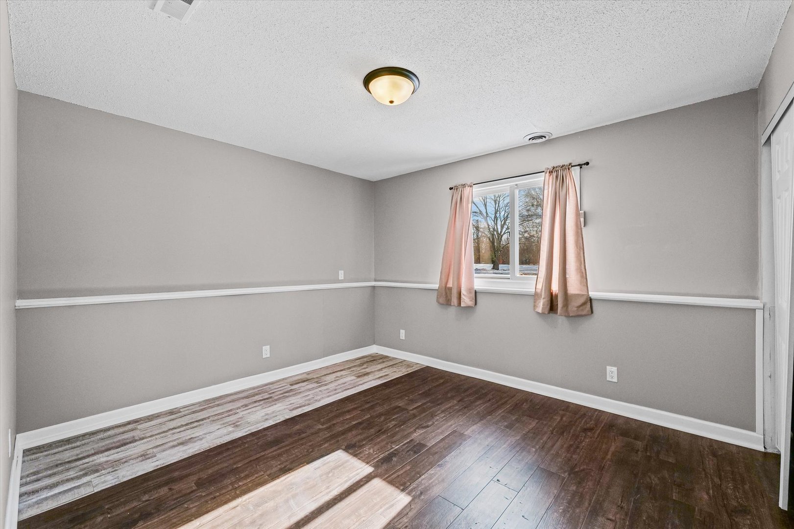 702 Devonshire Drive Champaign, IL 61820 - Photo 30 of 37 a view of empty room with wooden floor and fan