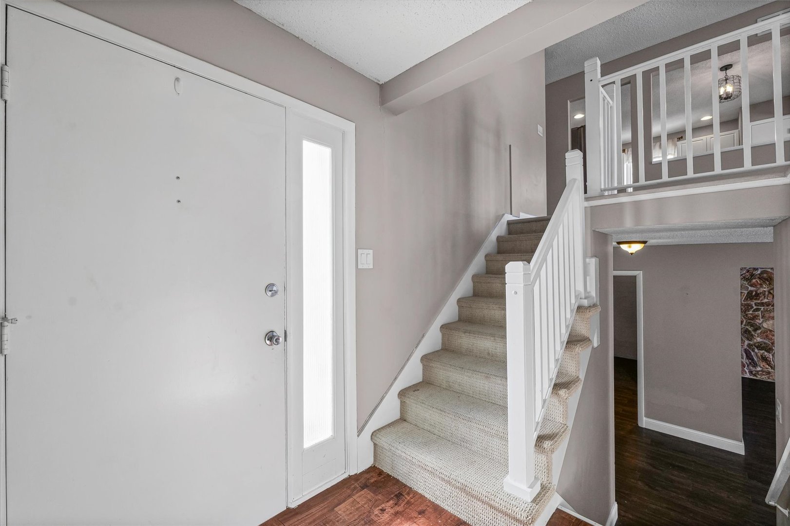 702 Devonshire Drive Champaign, IL 61820 - Photo 3 of 37 a view of staircase with lots of frames on wall and a window