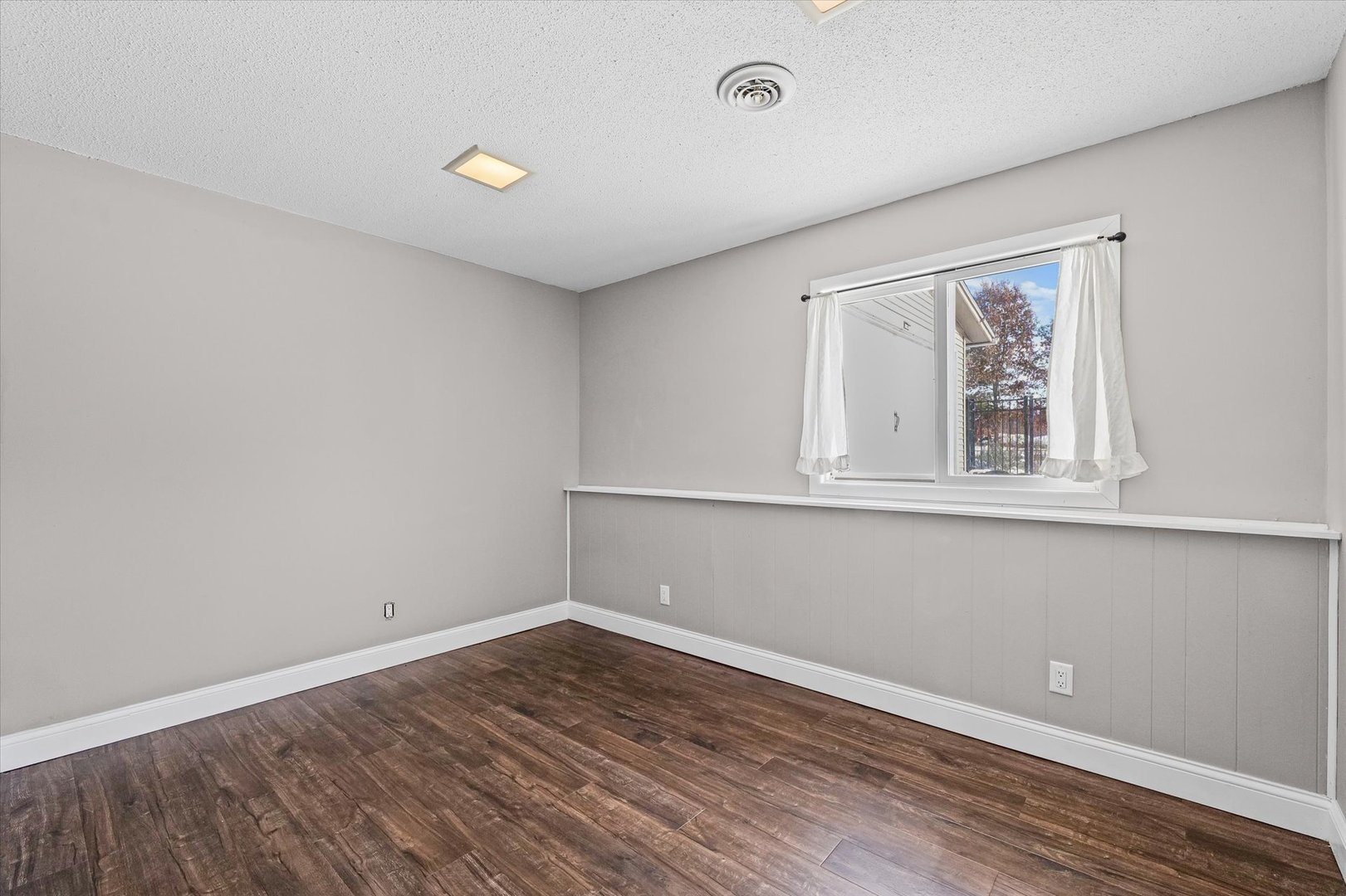 702 Devonshire Drive Champaign, IL 61820 - Photo 31 of 37 wooden floor in an empty room with a window