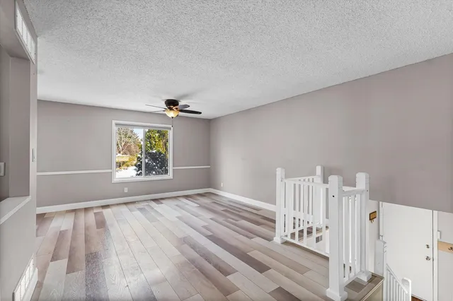 a view of a room with a window and ceiling fan