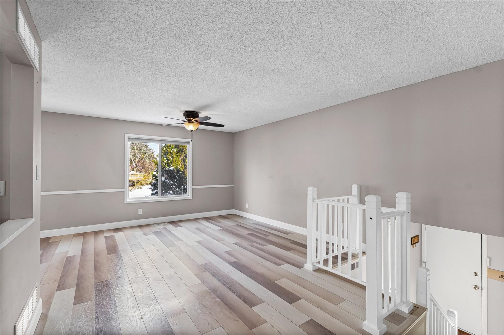 702 Devonshire Drive Champaign, IL 61820 - Photo 4 of 37 wooden floor in an empty room with a window