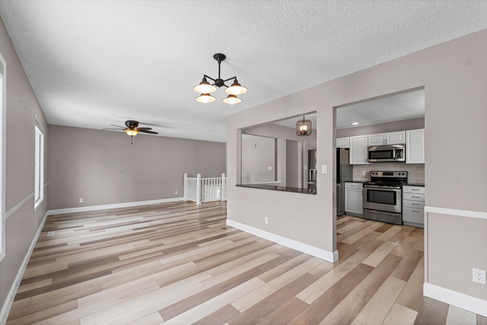 702 Devonshire Drive Champaign, IL 61820 - Photo 8 of 37 a view of a hallway with wooden floor and a kitchen