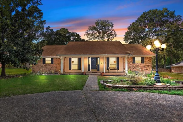 a front view of a house with a garden and porch