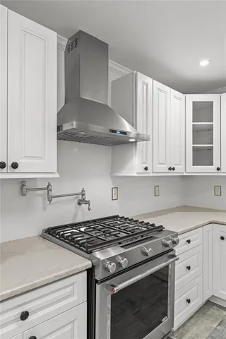 a white stove top oven sitting inside of a kitchen