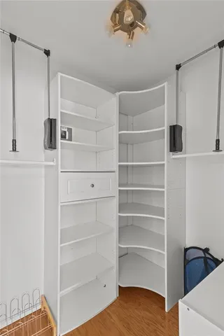 a view of walk in closet with empty racks