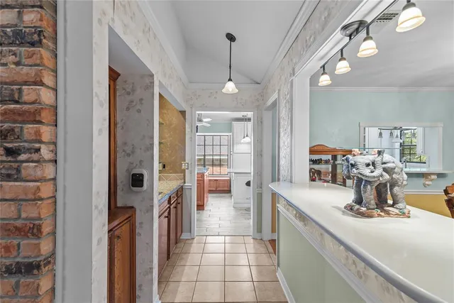 a hallway with a large mirror and cabinets