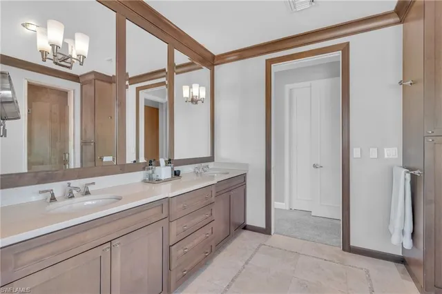 a bathroom with a double vanity sink and a mirror