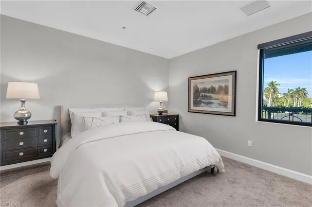 a bedroom with bed and wall painting