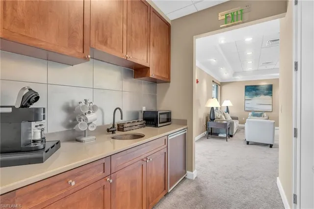 a kitchen with a sink and cabinets