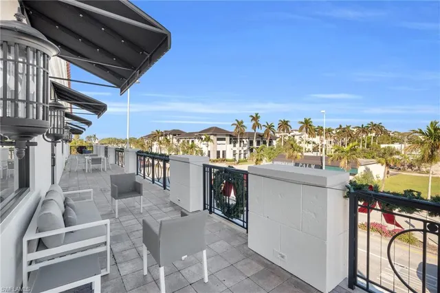 a view of a balcony with furniture and a rug