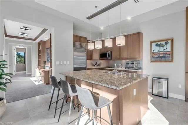a kitchen with stainless steel appliances granite countertop a sink and cabinets