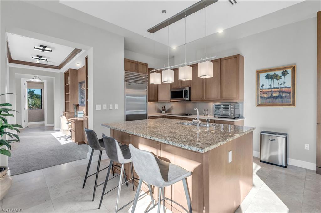 428 9th Street South Naples, FL 34102 - Photo 5 of 24 a kitchen with stainless steel appliances granite countertop a sink and cabinets