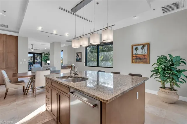 a kitchen with granite countertop a table and chairs in it