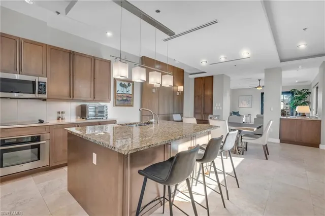 a large kitchen with granite countertop lots of counter space and windows