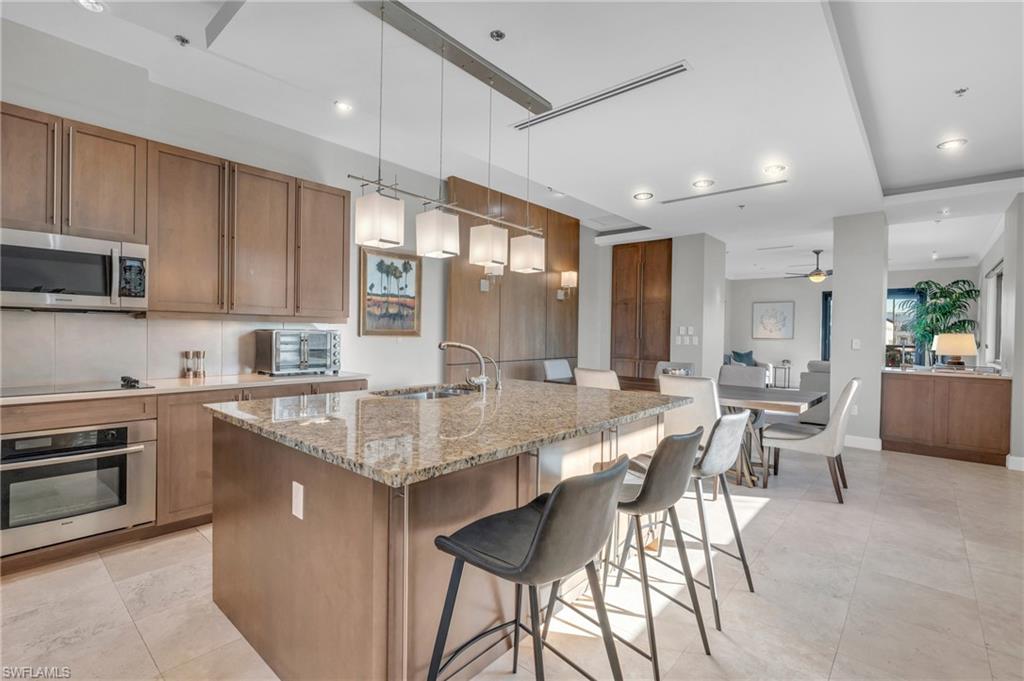 428 9th Street South Naples, FL 34102 - Photo 7 of 24 a large kitchen with granite countertop lots of counter space and windows