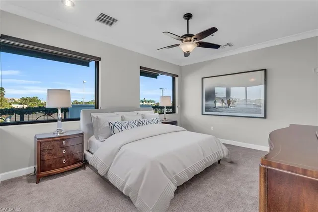 a bedroom with a large bed and a chandelier