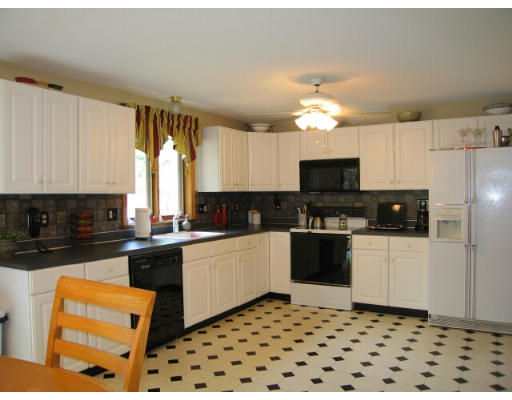 133 Munn Road Monson, MA 01057 - Photo 3 of 9 a kitchen with stainless steel appliances a stove a sink a microwave a refrigerator and cabinets